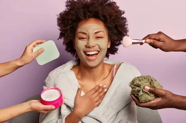 A photo of a POC lady with curly hair who is getting a SPA treatment