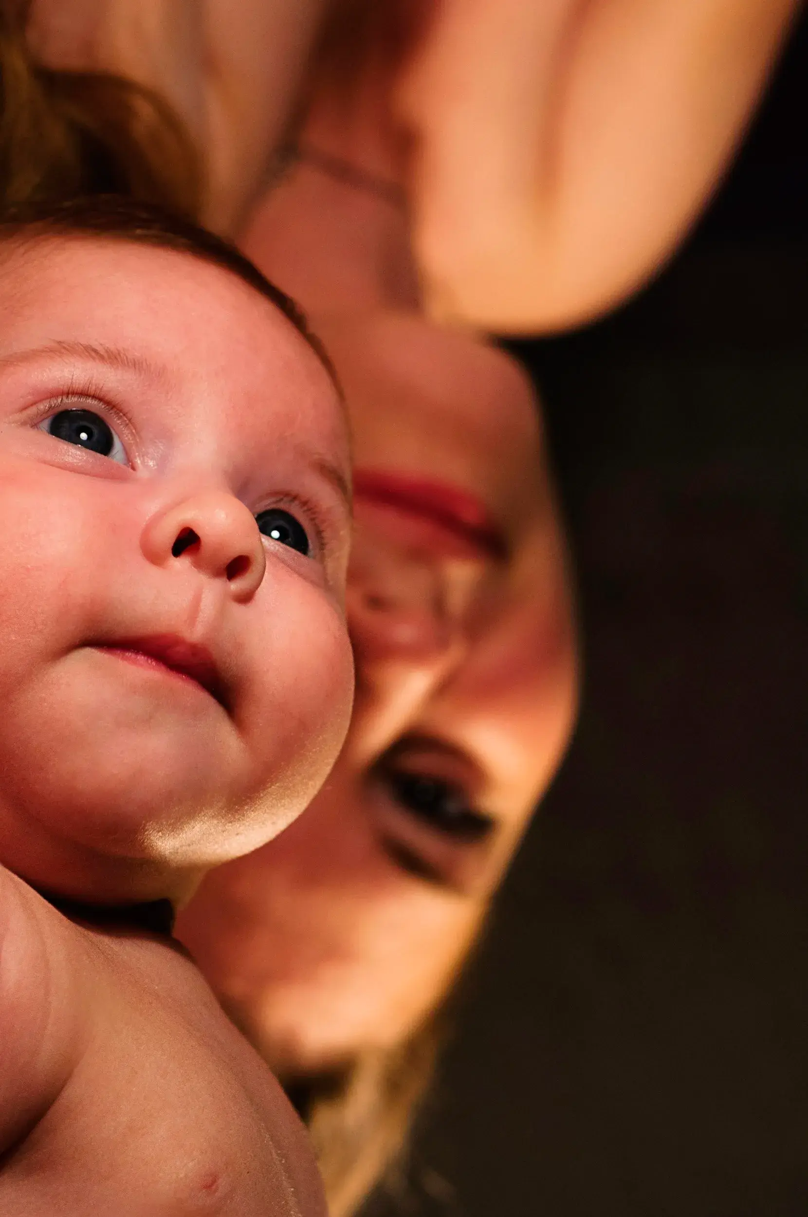 Mother holding a smiling newborn baby